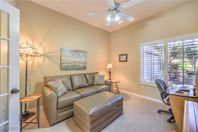 office space featuring light tile patterned floors, ceiling fan, and baseboards