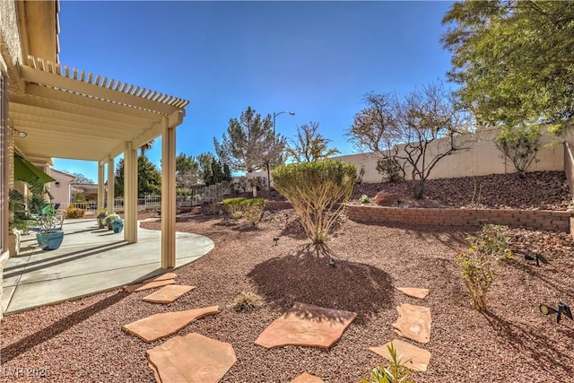 view of yard with a patio area, a fenced backyard, and a pergola