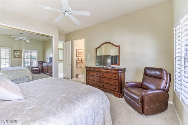 bedroom featuring ceiling fan, a closet, baseboards, and light colored carpet