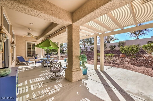 view of patio / terrace featuring outdoor dining space, a fenced backyard, a ceiling fan, and a pergola