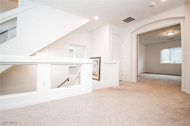 additional living space with light carpet, visible vents, and recessed lighting