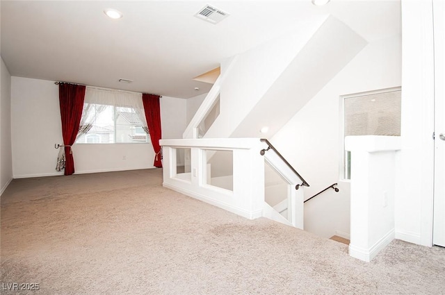 interior space with carpet floors, baseboards, visible vents, and recessed lighting