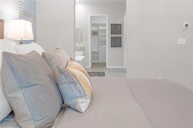 bedroom featuring a closet and a spacious closet