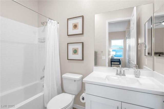 bathroom with vanity, shower / bath combo with shower curtain, and toilet