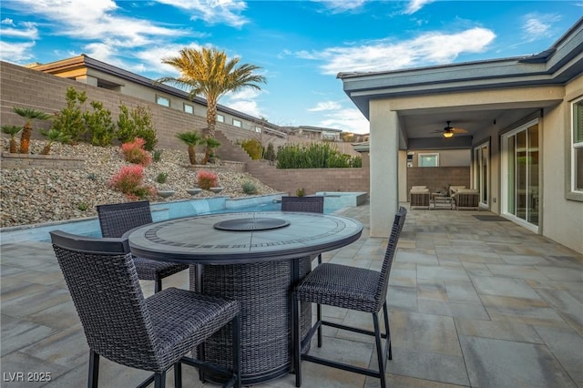 view of patio / terrace featuring ceiling fan, outdoor dining area, cooling unit, and a fenced backyard