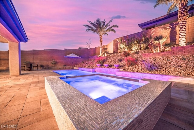 view of pool featuring an in ground hot tub, a patio area, and a fenced backyard