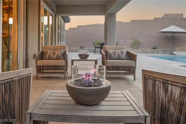 view of patio / terrace with an outdoor living space with a fire pit and a fenced in pool