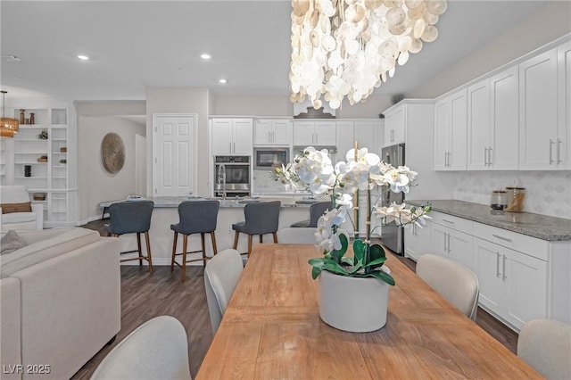 dining room with recessed lighting and wood finished floors