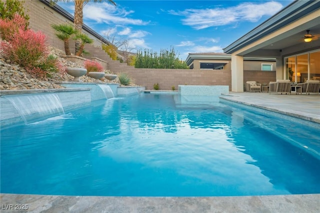 view of swimming pool with a patio, a fenced backyard, an outdoor living space, and a ceiling fan