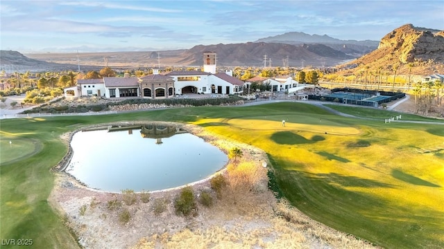 view of property's community featuring view of golf course and a water and mountain view