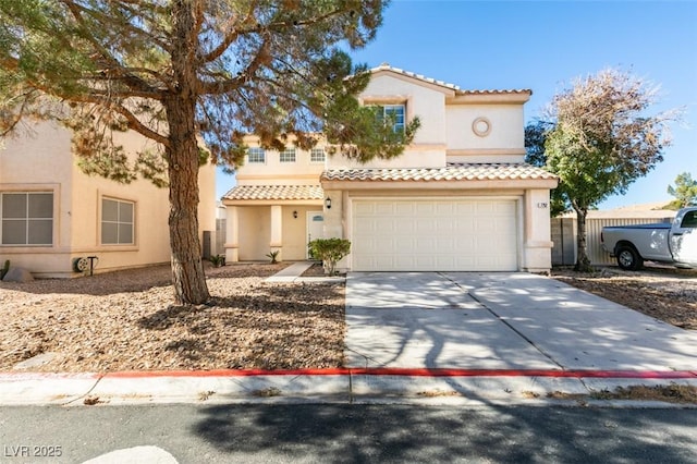 mediterranean / spanish-style home featuring driveway, a tiled roof, and stucco siding