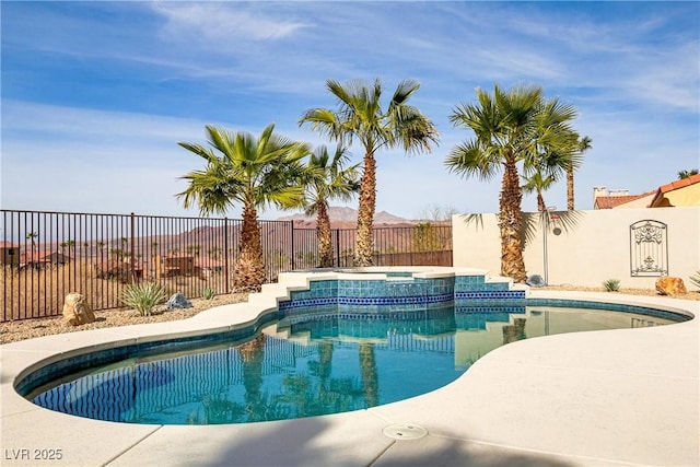 view of swimming pool with a fenced in pool, a fenced backyard, and an in ground hot tub