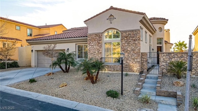 mediterranean / spanish-style home featuring driveway, a garage, stone siding, a tiled roof, and stucco siding