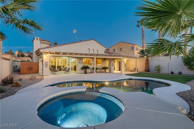 view of swimming pool featuring a fenced backyard, a patio, and an in ground hot tub