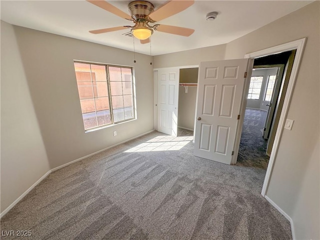 unfurnished bedroom with baseboards, ceiling fan, and light colored carpet