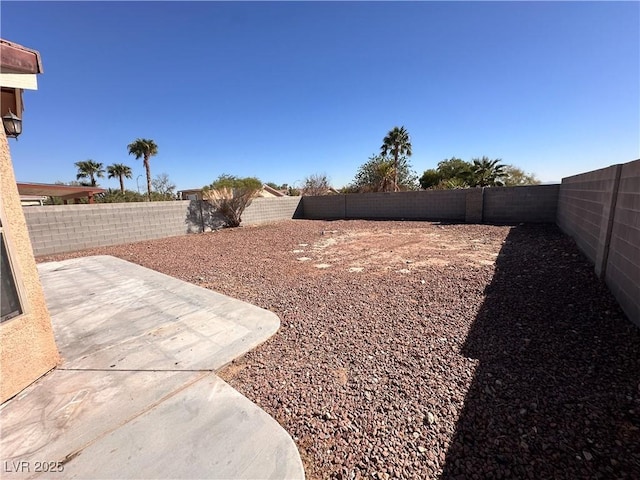 view of yard featuring a patio area and a fenced backyard