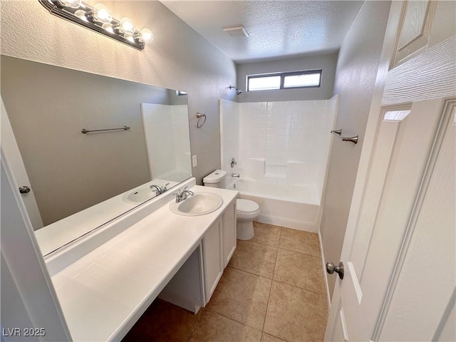 bathroom featuring a textured ceiling, tile patterned flooring, toilet, vanity, and shower / bathing tub combination