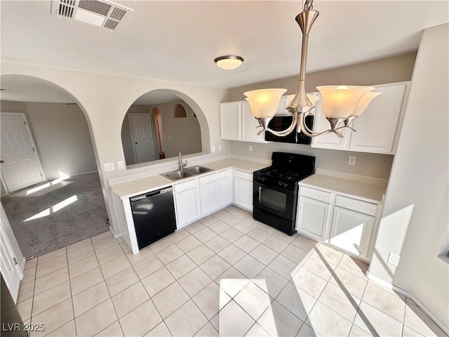 kitchen featuring a sink, white cabinetry, light countertops, black appliances, and decorative light fixtures