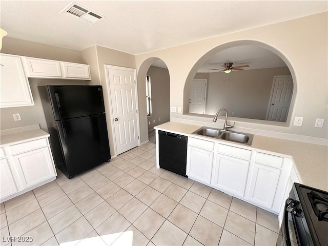 kitchen with light countertops, visible vents, a sink, and black appliances