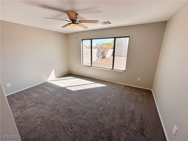 carpeted empty room with a ceiling fan, visible vents, and baseboards