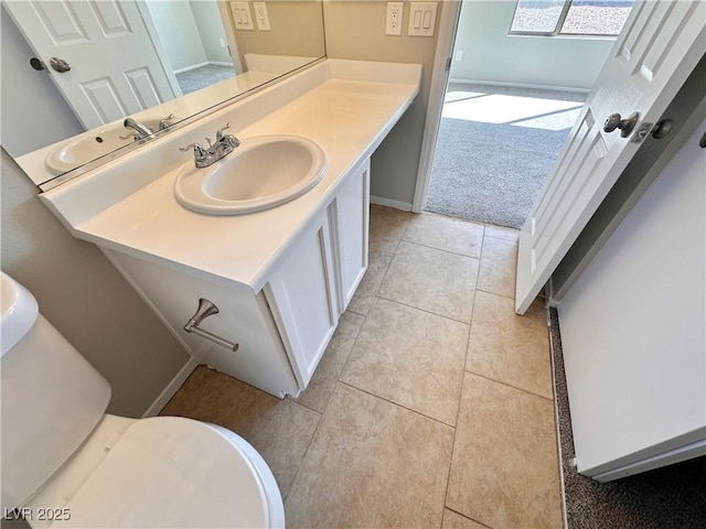 bathroom featuring baseboards, vanity, and tile patterned floors