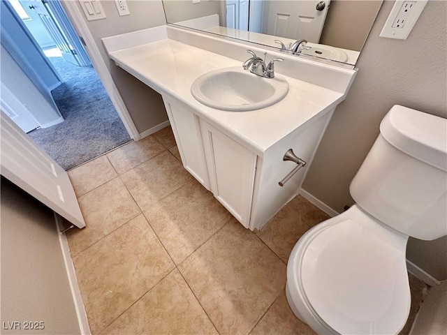 half bath featuring toilet, tile patterned flooring, baseboards, and vanity