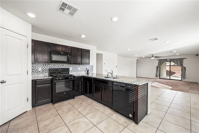 kitchen featuring a peninsula, a sink, visible vents, open floor plan, and black appliances