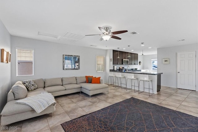 living room featuring recessed lighting, light tile patterned flooring, visible vents, and a ceiling fan