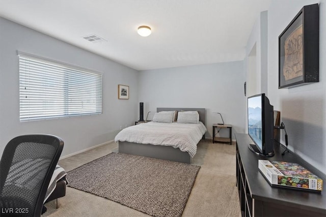 bedroom with baseboards, visible vents, and light colored carpet