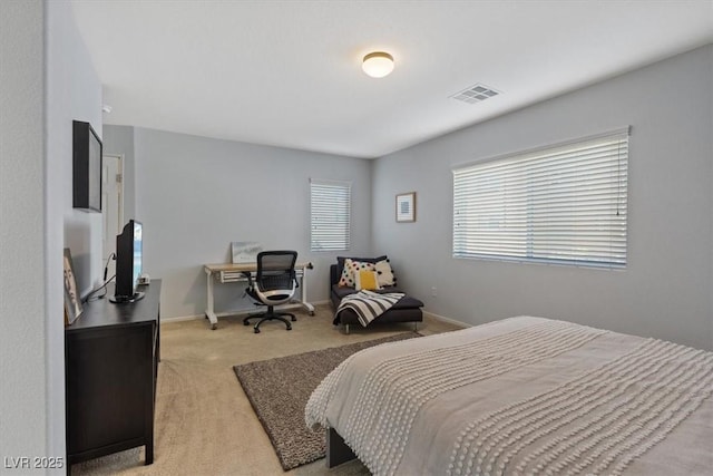 bedroom featuring light carpet, baseboards, and visible vents