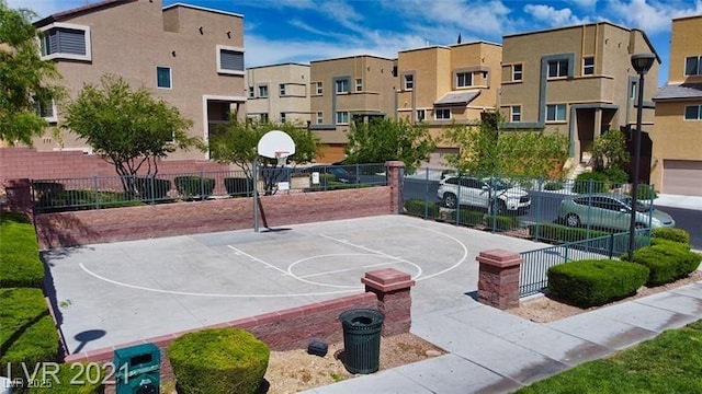 view of sport court with community basketball court, a residential view, and fence