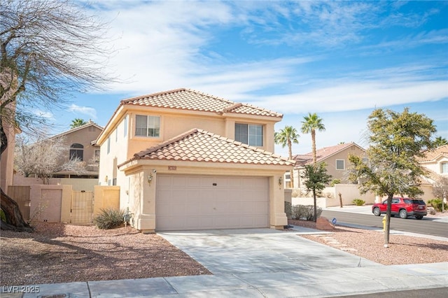 mediterranean / spanish home featuring a garage, concrete driveway, a tiled roof, fence, and stucco siding