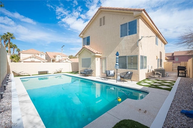 view of pool with a patio, a fenced backyard, central AC, a residential view, and a fenced in pool