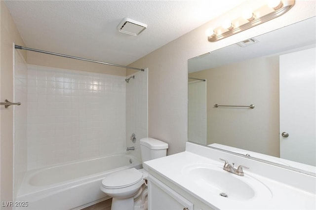 full bath with a textured ceiling, toilet, vanity, visible vents, and shower / washtub combination