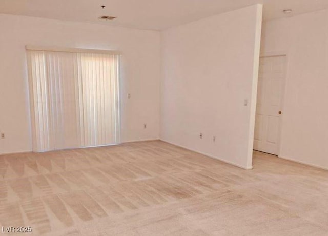 spare room with light carpet and visible vents