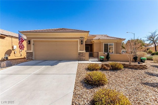 prairie-style home with a garage, fence, driveway, stone siding, and stucco siding