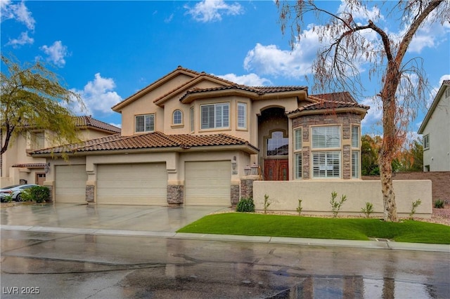 mediterranean / spanish-style home featuring concrete driveway, stone siding, a tiled roof, fence, and stucco siding