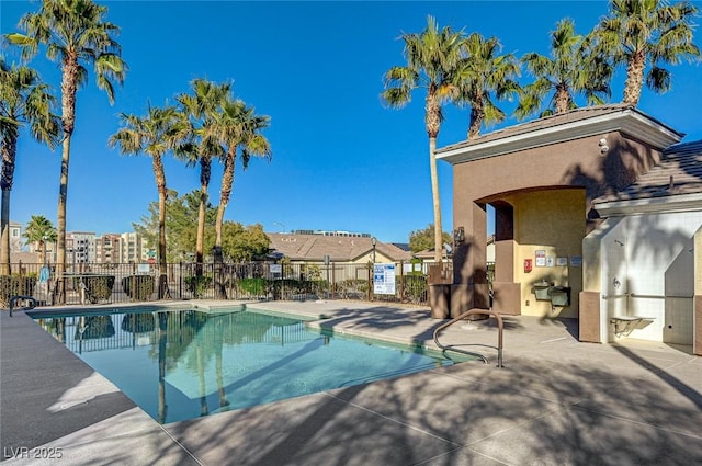 community pool featuring a patio area and fence