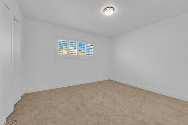 unfurnished room featuring carpet flooring and baseboards