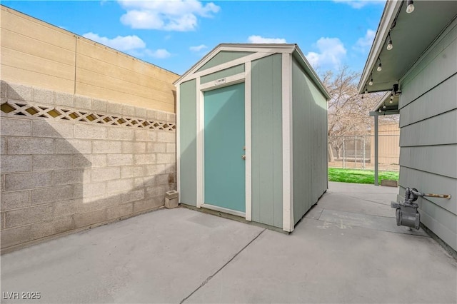 view of shed featuring fence