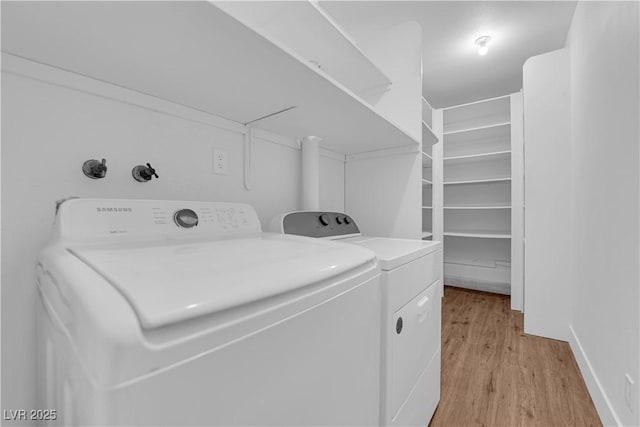 washroom featuring laundry area, light wood-style floors, and independent washer and dryer