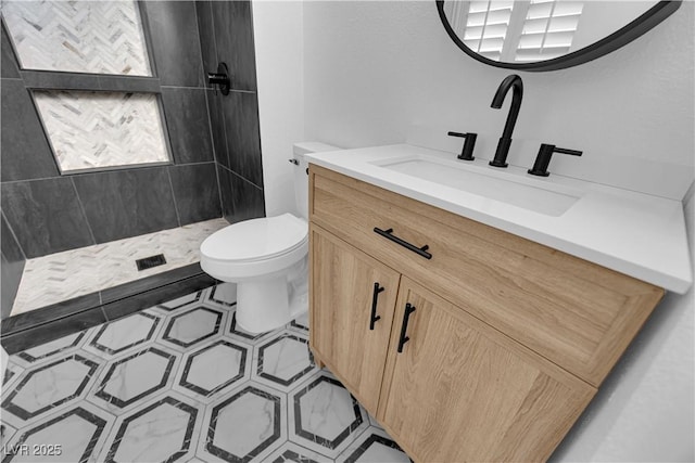 bathroom featuring a stall shower, tile patterned flooring, vanity, and toilet