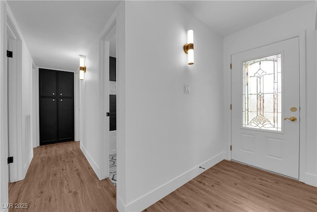 entrance foyer with light wood-type flooring and baseboards