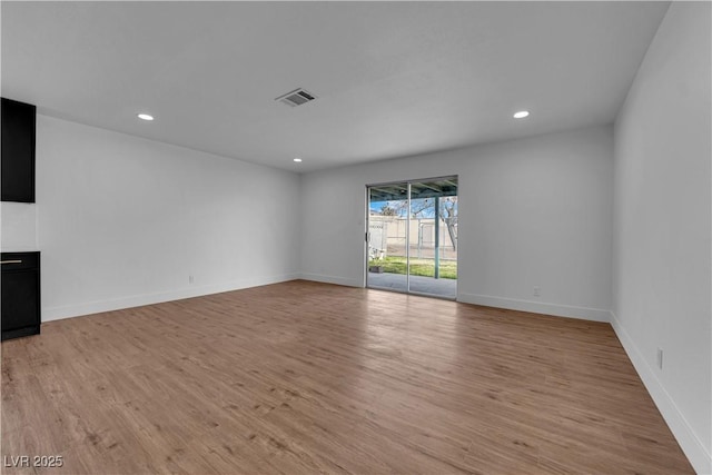 unfurnished living room with light wood-style floors, recessed lighting, visible vents, and baseboards