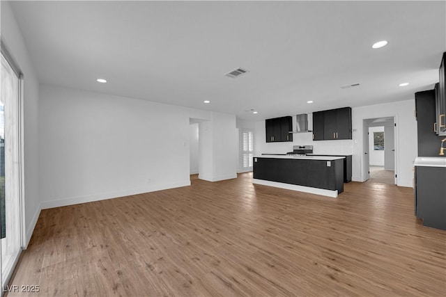 unfurnished living room with recessed lighting, visible vents, and light wood finished floors