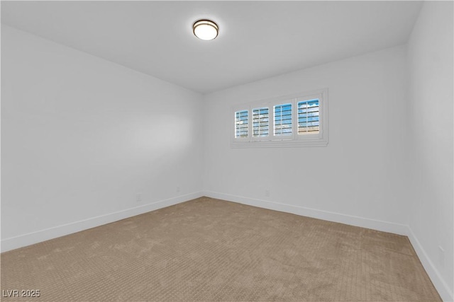 unfurnished room with light carpet and baseboards