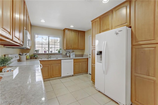 kitchen featuring recessed lighting, a sink, light tile patterned flooring, light stone counters, and white appliances