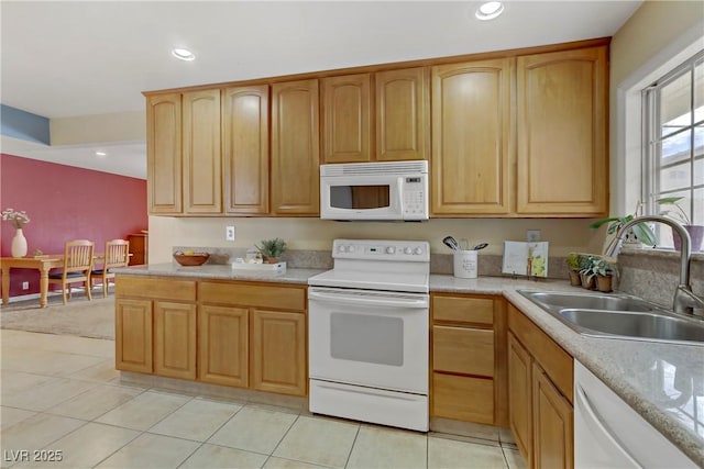 kitchen with light countertops, recessed lighting, a sink, and white appliances