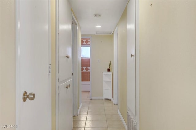 hall with light tile patterned flooring and visible vents