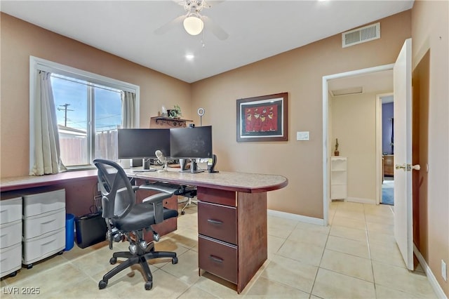 office area with baseboards, visible vents, light tile patterned floors, and ceiling fan